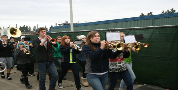 Keep on marching: Sophomore drum major Griffin Ditmar leads the marching band towards the school to send the womens soccer team off to state on November 15. Marching through the halls, the band roused the LHS populace with several songs, including pop hits Louie Louie and Little Lion Man.