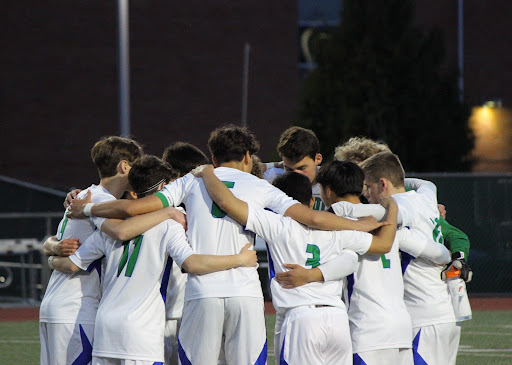 Team meeting: The Liberty boys’ soccer team shows team unity and support after their April 5th win against Hazen.